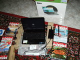 Aluminium Dell Inspiron N5010 booting Windows 7 on battery, near the original box.