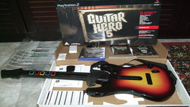 Guitar Hero 5 game for PlayStation 2 - box, covers, manual, wireless controller and DVD.