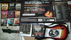 Guitar Hero 5 game for PlayStation 2 - back side of the box, poster and DVD.